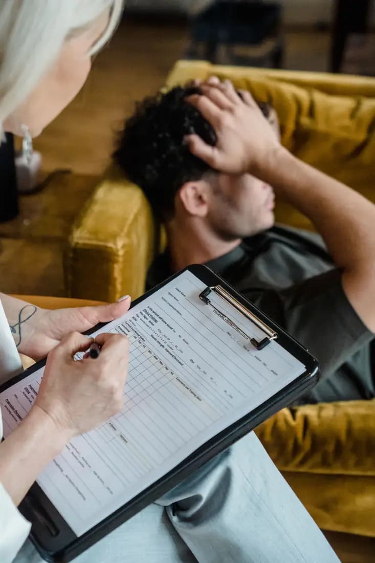Therapist taking notes during a counselling session