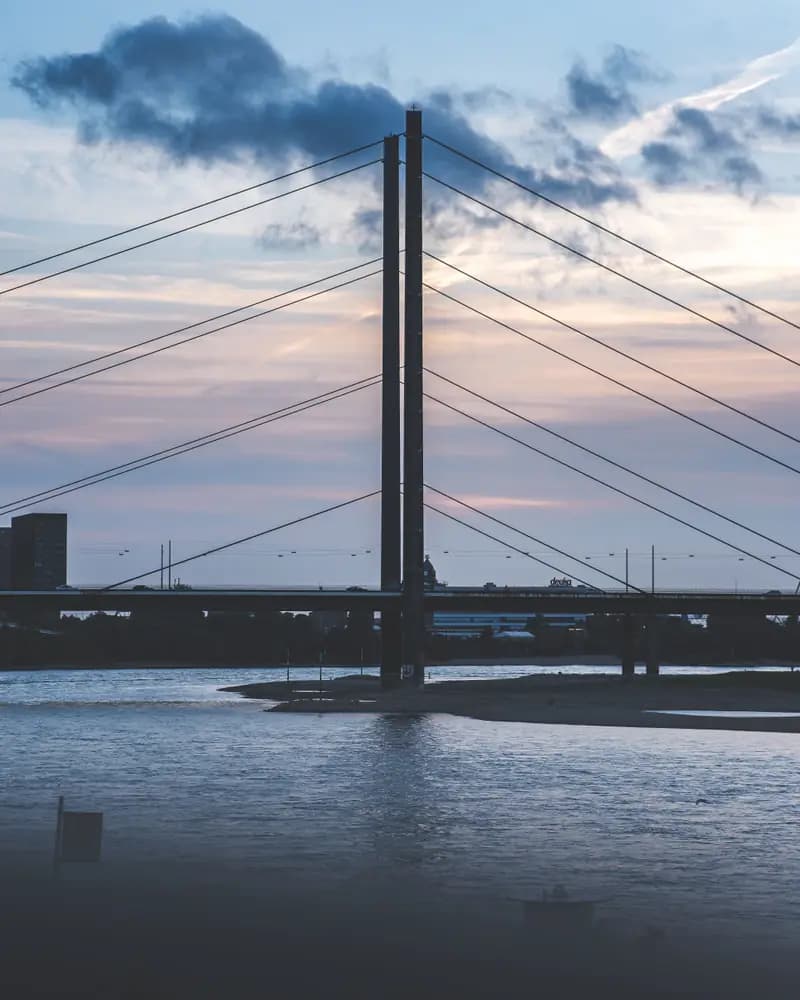 Cable-stayed bridge over a river at dusk