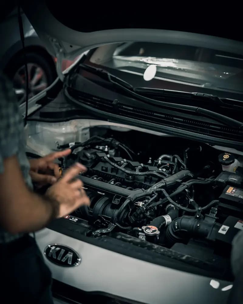 Technician working on a car engine